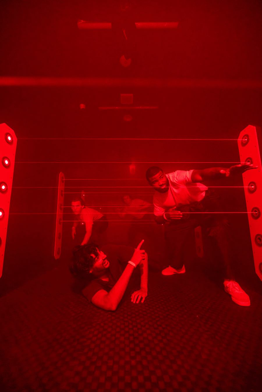 People trying to cross the room hidding from the lasers.