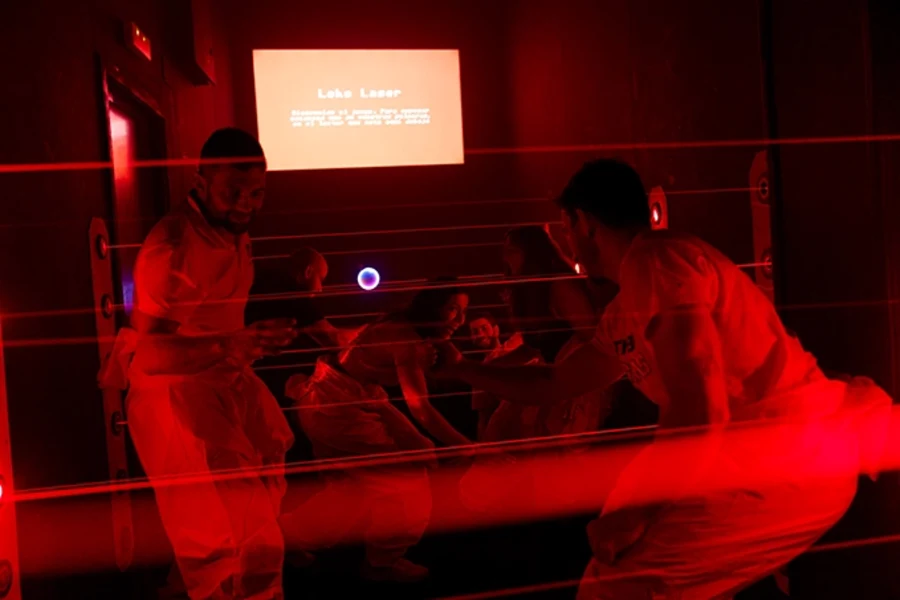 People avoiding the lasers in a red room